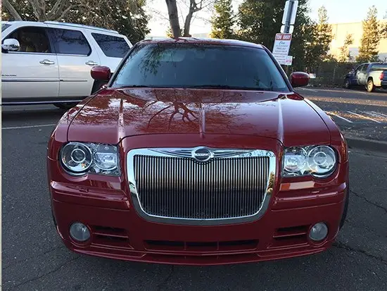 Same maroon sedan after front rebuild