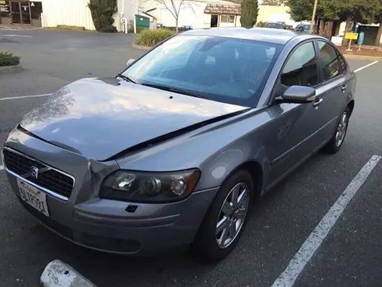 Damaged silver sedan before front-end repair