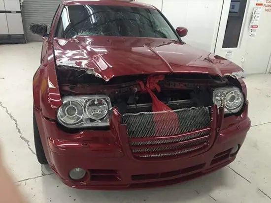 Damaged maroon sedan before front rebuild